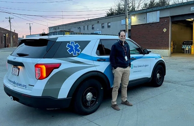 male paramedic standing by an ambulance